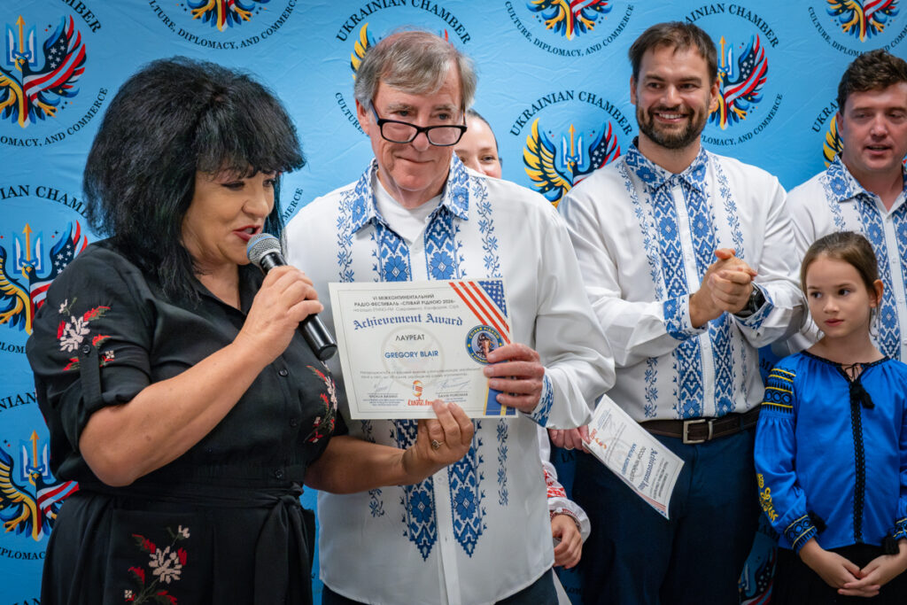 Natalia Bahmut presents an award to an American singer during the Sing Native festival in Dallas, Texas.