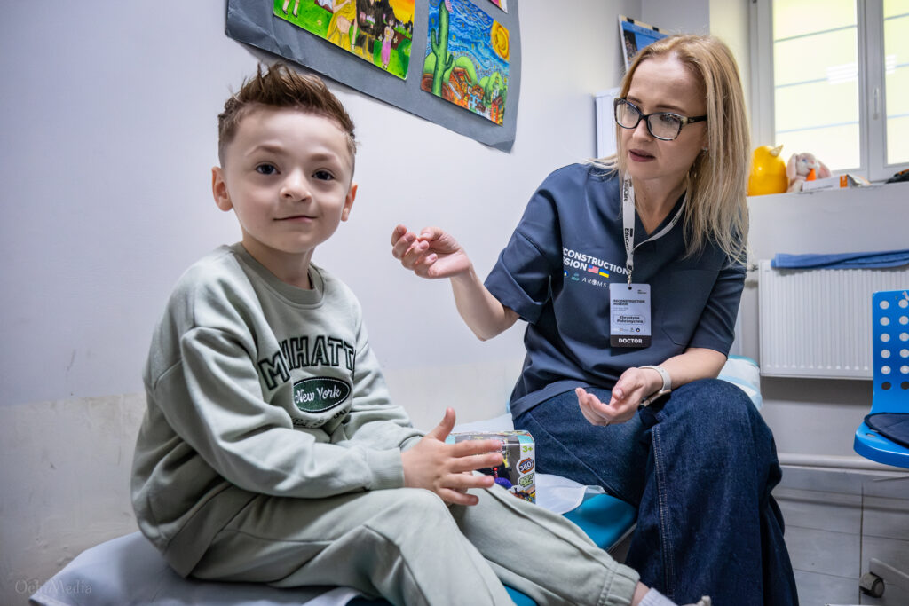Dr. Khrystyna Pohranichna consults with a young patient during an international cleft and craniofacial surgical mission in Lviv, Ukraine.