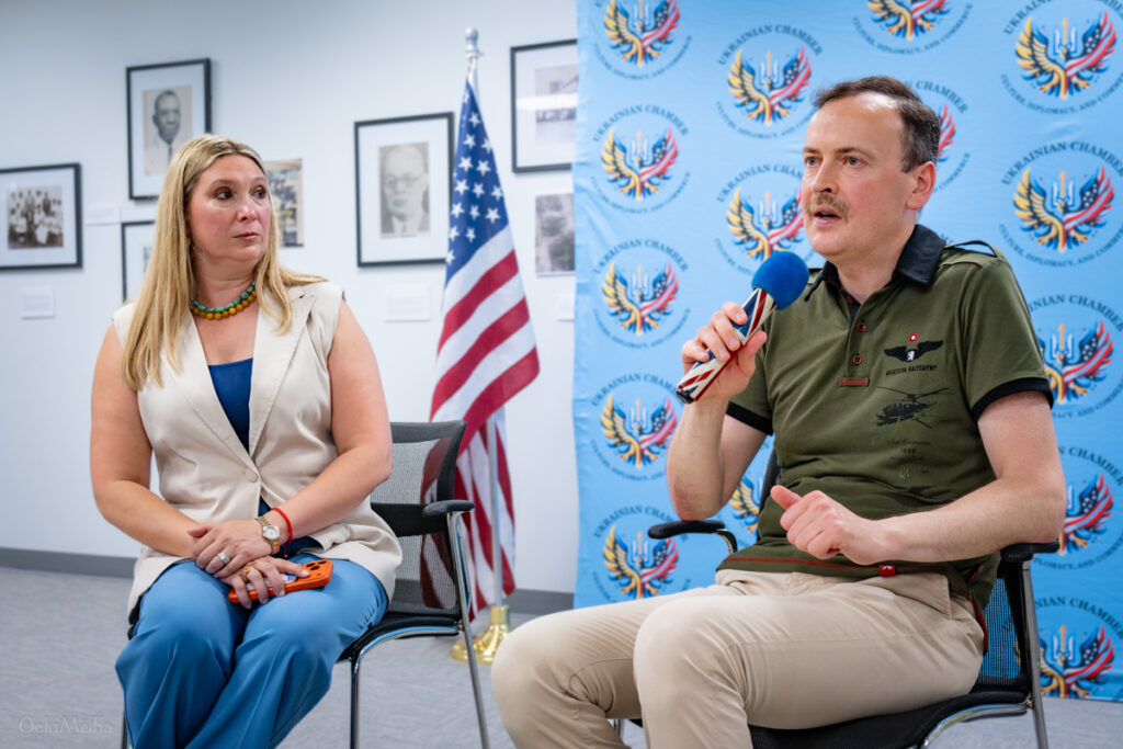 Consul General of Ukraine in Houston Vitalii Moshkivskyi speaks during a Ukrainian community meeting in Dallas as U.S.–Ukrainian Chamber of Commerce President Tamara Velsher listens.